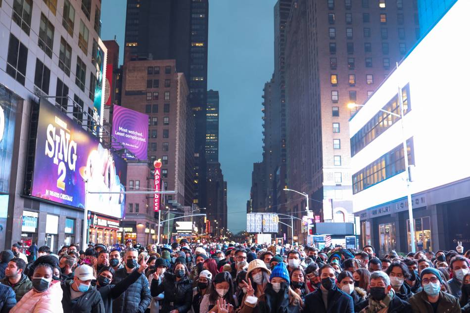 People gather before New Year's Eve celebrations begin in Times Square in Manhattan, December 31, 2021, as the omicron coronavirus variant continues to spread. Hannah Beier, Reuters