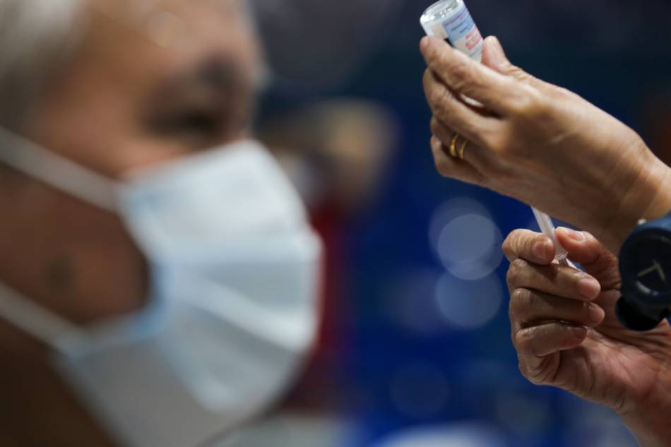 Residents receive their COVID-19 booster shots at the FilOil Arena as the City of San Juan resumes its vaccination for its residents on January 03, 2021. Jonathan Cellona, ABS-CBN News/File