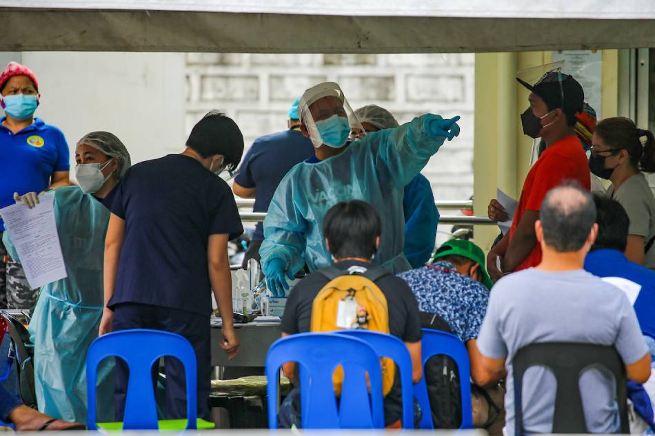 Health workers attend to people with various ailments at the Sta. Ana Hospital's triage area in Manila on Jan. 7, 2022. Jonathan Cellona, ABS-CBN News