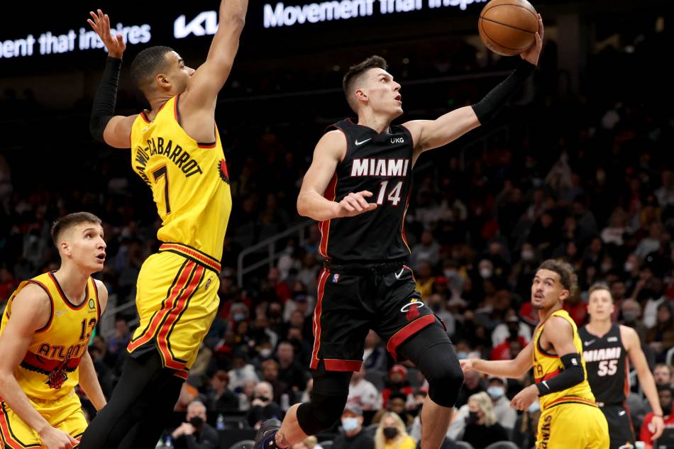 Miami Heat guard Tyler Herro (14) shoots against Atlanta Hawks guard Timothe Luwawu-Cabarrot (7) during the second quarter at State Farm Arena. Jason Getz, USA TODAY Sports/Reuters.