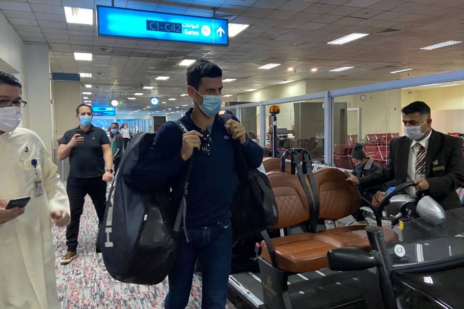 Serbian tennis player Novak Djokovic walks at Dubai Airport after the Australian Federal Court upheld a government decision to cancel his visa to play in the Australian Open, in Dubai, United Arab Emirates, January 17, 2022. Abdel Hadi Ramahi, Reuters.