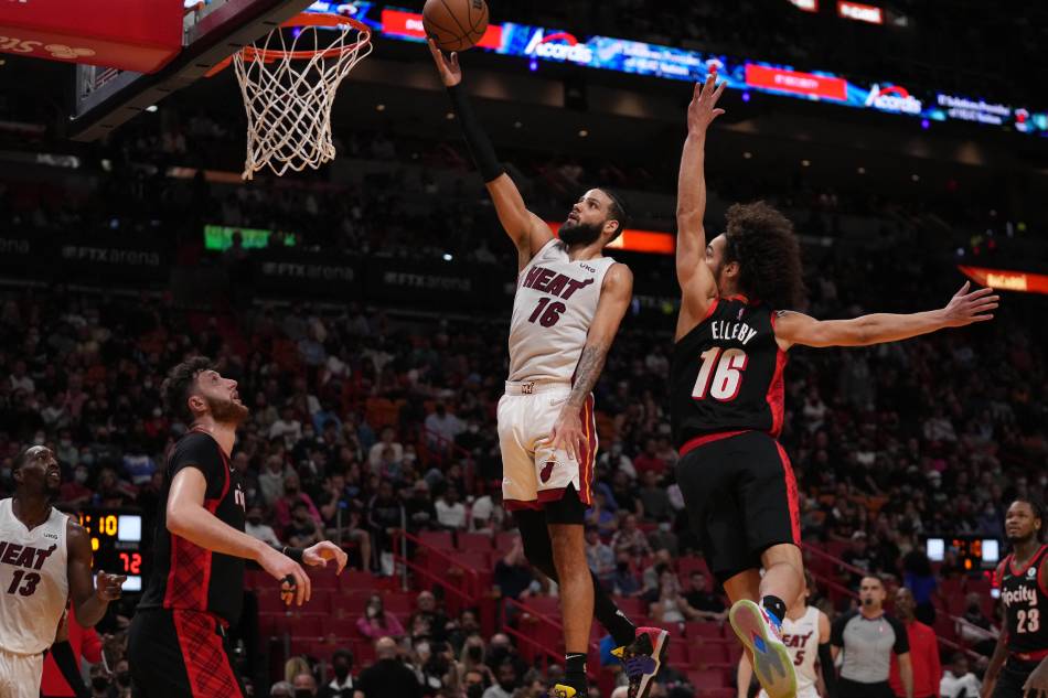 Miami Heat forward Caleb Martin (16) puts up a shot over Portland Trail Blazers center Jusuf Nurkic (27) and guard CJ Elleby (16) during the second half at FTX Arena. Jasen Vinlove, USA TODAY Sports/Reuters.