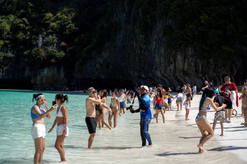 Tourists visit Maya bay after Thailand reopened its world-famous beach after closing it for more than 3 years to allow its ecosystem to recover from the impact of overtourism, at Krabi province, Thailand, Jan. 3, 2022. Athit Perawongmetha, Reuters/File