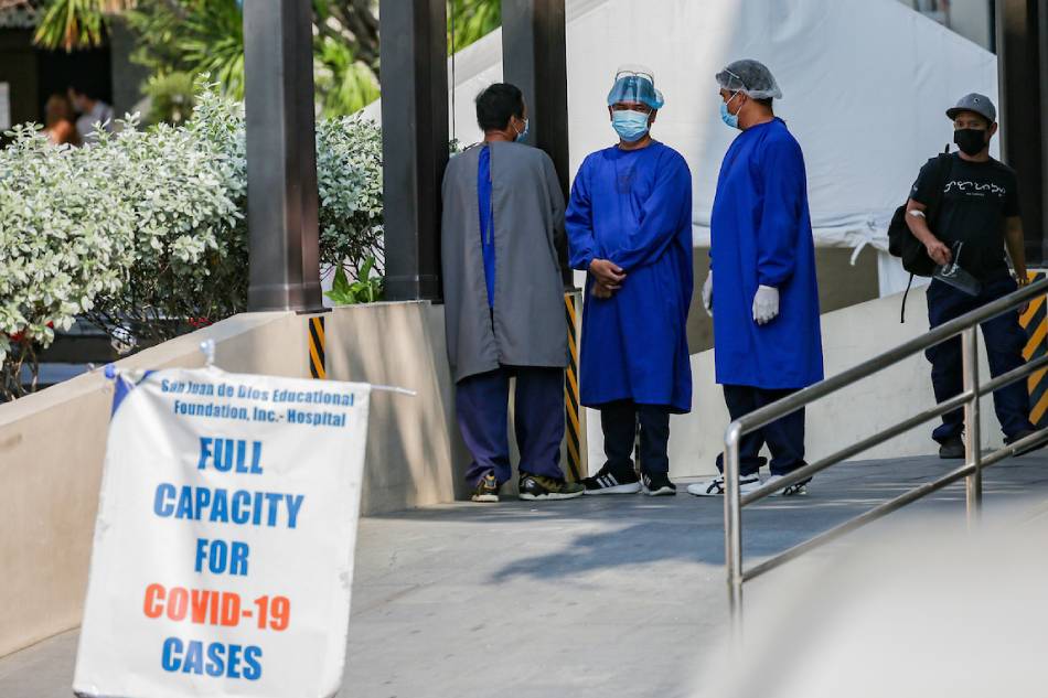 Health workers spend time outside the emergency room of San Juan De Dios Hospital in Pasay City on January 12, 2022. The sudden increase of COVID-19 cases this year has caused some hospitals in Metro Manila to declare full capacity. George Calvelo, ABS-CBN News