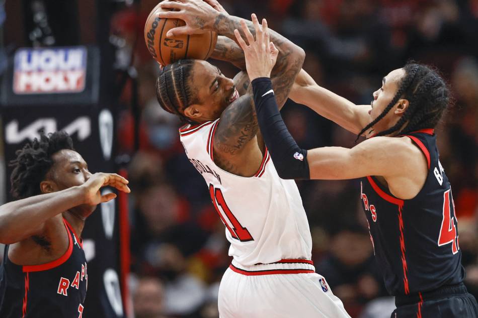 Chicago Bulls forward DeMar DeRozan (11) is defended by Toronto Raptors guard Dalano Banton (45) during the second half at United Center. Kamil Krzaczynski, USA TODAY Sports/Reuters.