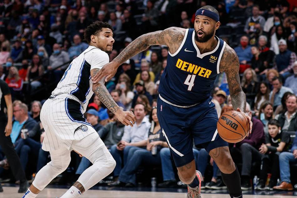 Denver Nuggets center DeMarcus Cousins (4) controls the ball as Orlando Magic forward Chuma Okeke (3) guards in the fourth quarter at Ball Arena. Isaiah J. Downing, USA TODAY Sports/Reuters.