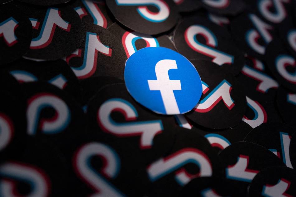 Printed Facebook and TikTok logos are seen in this illustration taken February 15, 2022. Dado Ruvic, Reuters Illustration