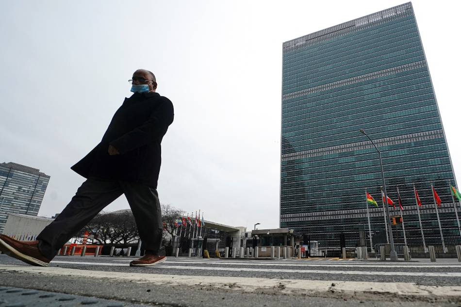 A person walks across the street in front of the United Nations building in the Manhattan borough of New York City, U.S., February 22, 2022. Carlo Allegri, Reuters/File