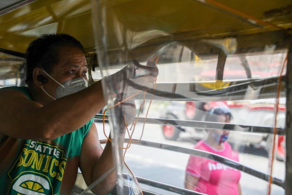 Angelo Romeo, 60, installs plastic barriers inside his jeep at a terminal in Mazaraga Street, Tatalon, Quezon City on Monday. Plying the Araneta- Sta. Mesa route, Romeo had to queue for his turn to ferry passengers amid the strict implementation of health protocols under the enhanced community quarantine in Metro Manila. Jonathan Cellona, ABS-CBN News/File