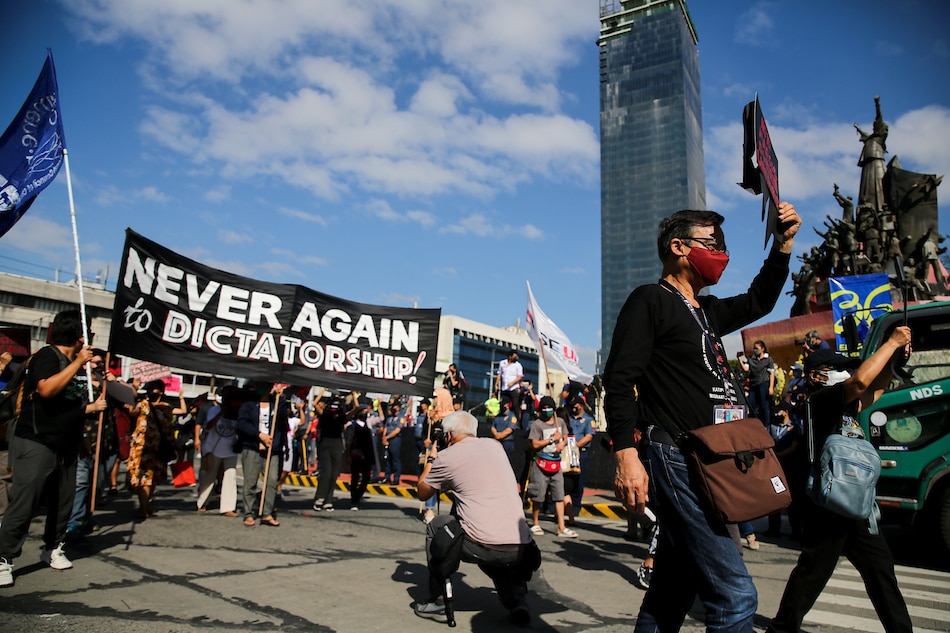Protesters march to the EDSA People Power Monument on the occasion of the 36th anniversary of the EDSA People Power revolution at the People Power Monument on EDSA in Quezon City on Feb. 25, 2022. Jonathan Cellona, ABS-CBN News