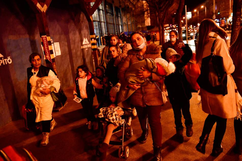 Mothers fleeing with their children from Ukraine stand at Nyugati station, after Russia launched a massive military operation against Ukraine, in Budapest, Hungary, February 27, 2022. Marton Monus, Reuters
