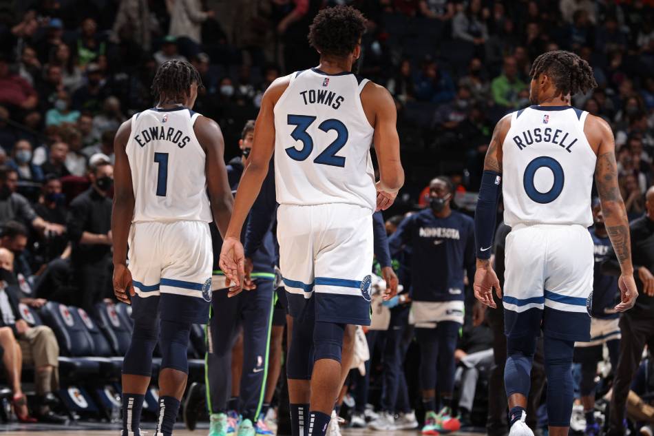 Anthony Edwards #1, Karl-Anthony Towns #32 and D'Angelo Russell #0 of the Minnesota Timberwolves walk off the court against the New Orleans Pelicans on October 25, 2021 at Target Center in Minneapolis, Minnesota. File photo. David Sherman, NBAE via Getty Images/AFP.