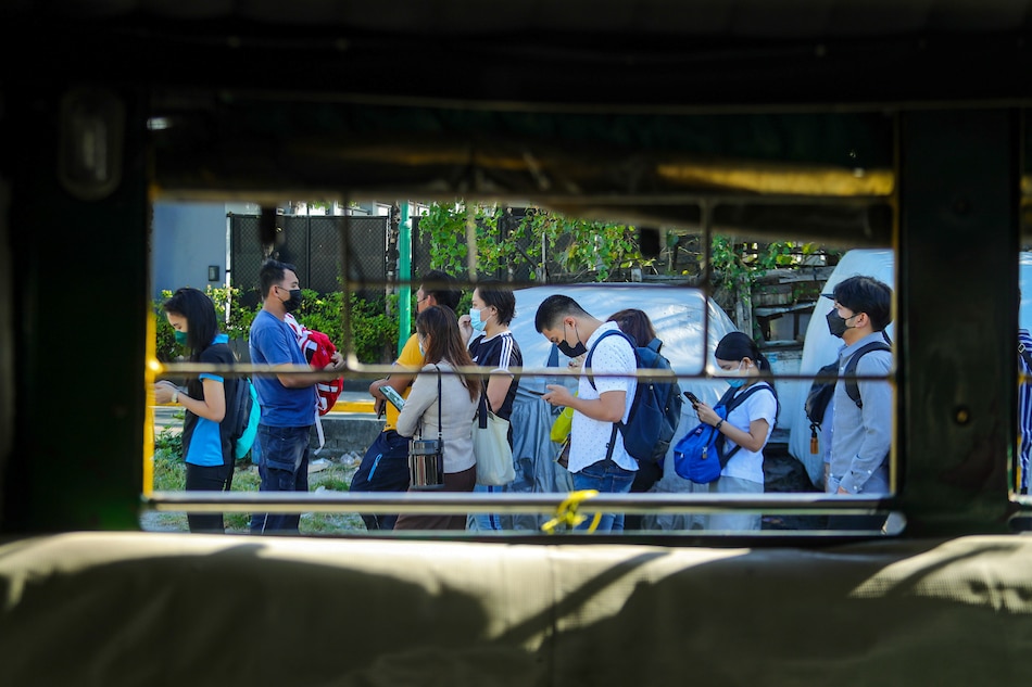 Commuters board a jeepney at a transport terminal on Tejeros Street in Makati City on March 01, 2022, on the first day under COVID-19 Alert Level 1 status. Jonathan Cellona, ABS-CBN News