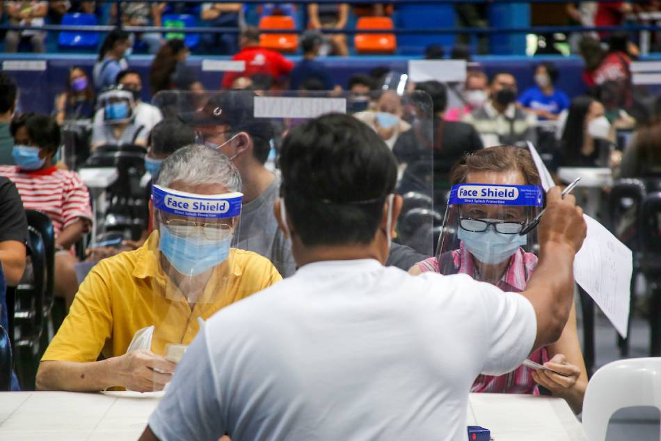 Senior citizens receive their Covid-19 vaccine booster shots at the Filoil San Juan Arena in San Juan City on December 03, 2021. Jonathan Cellona, ABS-CBN News