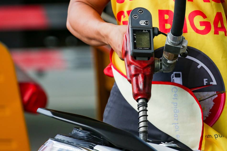 A motorcycle rider stops for a refill at a gasoline station in Manila on February 26, 2022. Gasoline prices which already increased for 8 straight weeks recently are expected to rise further amid the escalating conflict between Ukraine and Russia. George Calvelo, ABS-CBN News