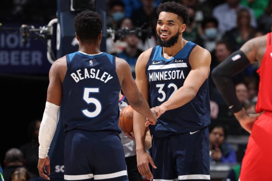 Malik Beasley (5) hi-fives Karl-Anthony Towns (32) of the Minnesota Timberwolves during the game against the Portland Trail Blazers at Target Center in Minneapolis, Minnesota. David Sherman, NBAE via Getty Images/AFP