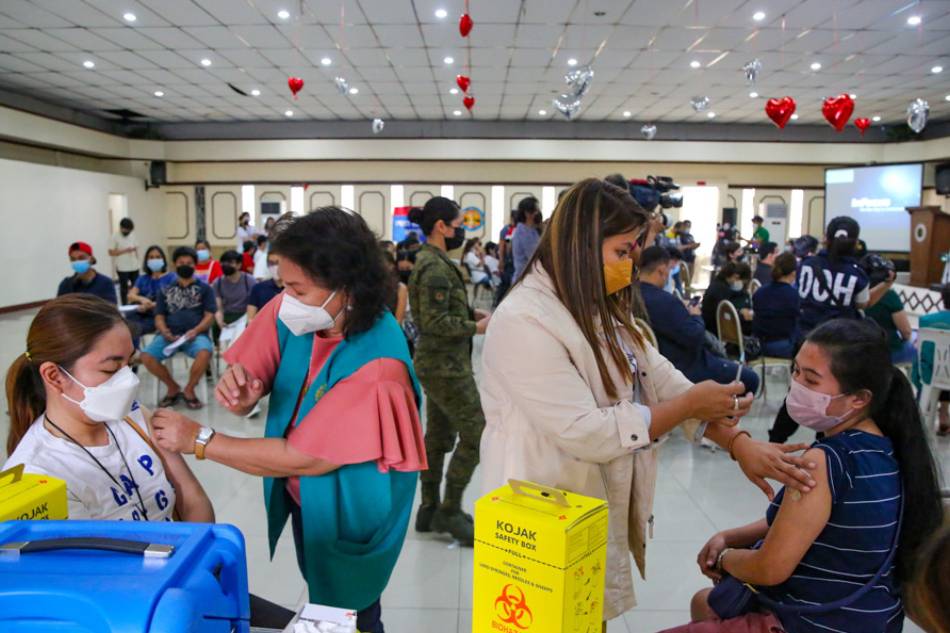 People come and receive their COVID-19 jabs during the National Vaccination Days part 4, at the Philippine Medical Association (PMA) headquarters in Quezon City on March 10, 2022. Jonathan Cellona, ABS-CBN News