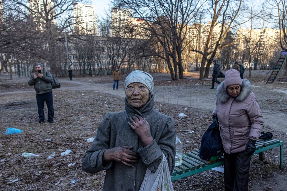 Local residents from the residential building which was hit by artillery shelling stand in front of the building, in Kyiv, Ukraine, March 15, 2022. Russian troops entered Ukraine on Feb. 24, prompting the country