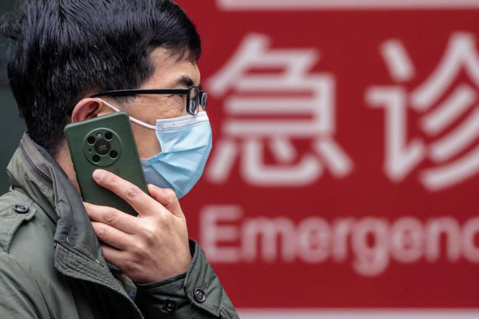 A man stands in front of the hospital, in Shanghai, China, 19 March 2022. On 19 March 2022, China reported 2,157 locally transmitted COVID-19 cases and 1,713 asymptomatic infections, according to the National Health Commission. EPA-EFE/ALEX PLAVEVSKI