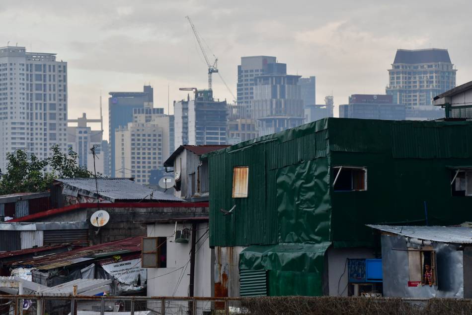 The Makati skyline looms behind a slum area in Pasay City on January 28, 2021. Mark Demayo, ABS-CBN News/File