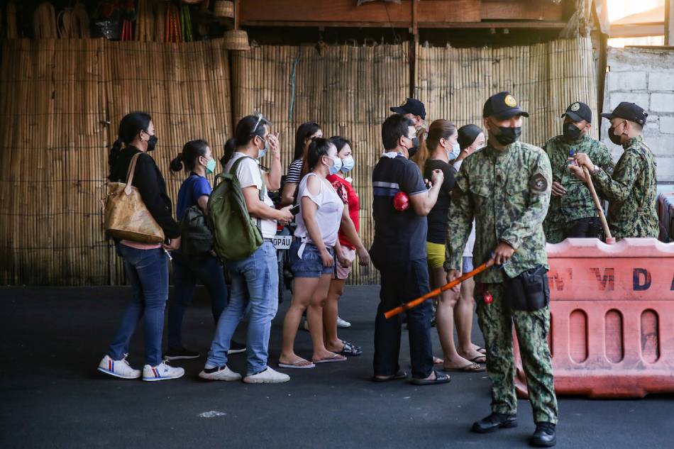 Police officers man the surrounding area of the Quiapo Church on Jan. 8, 2022. Authorities placed plastic barriers and cordoned off the roads leading to the church to prevent devotees from coming as COVID19 cases continue to rise. George Calvelo, ABS-CBN News