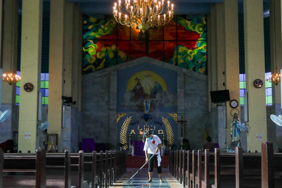 A volunteer cleans the premises of the Our Lady of Lourdes Grotto Shrine in Bulacan on March 31, 2022 as Holy Week nears. The shrine is maintained regularly with visitors expected to flock to the area for Holy Week due to the eased COVID-19 quarantine protocols. Jonathan Cellona, ABS-CBN News