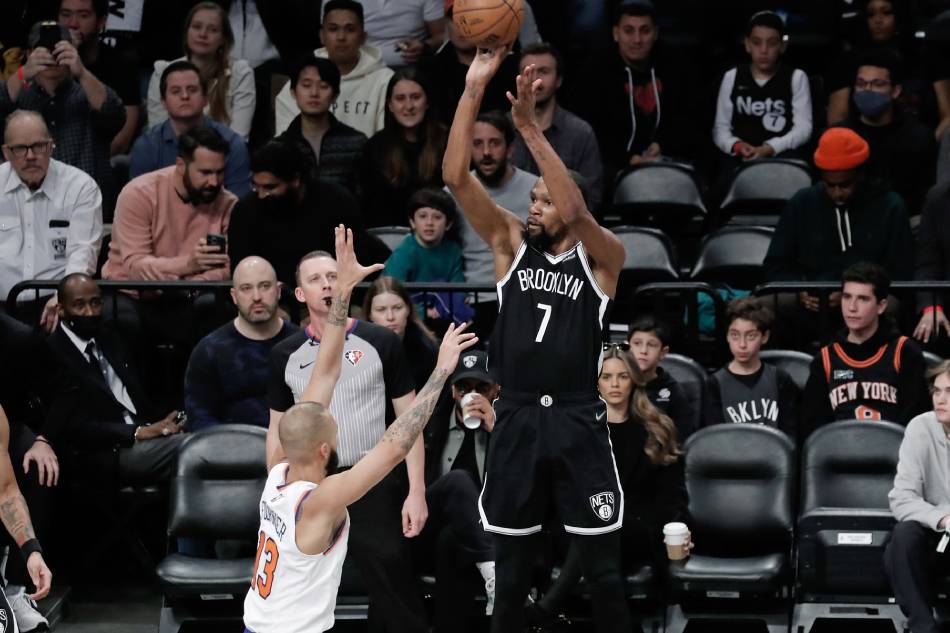 Brooklyn Nets forward Kevin Durant shoots (C) shoots over New York Knicks guard Evan Fournier during the first half of the NBA basketball game between the Brooklyn Nets and the New York Knicks at Barclays Center in Brooklyn, New York, USA, 13 March 2022. File photo. Peter Foley, EPA-EFE