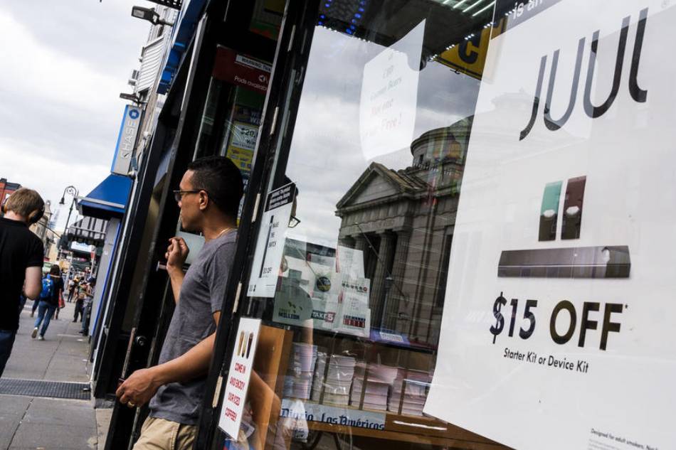 A sign advertises Juul pods, used for vaping in e-cigarettes, outside of a store in New York, New York, USA, Sept. 13 2019. Justin Lane, EPA-EFE/File 