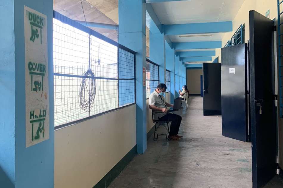 Teachers work at the corridors of a public high school in Quezon City just to get adequate internet signal. Photo courtesy of Ruby Ana Bernardo