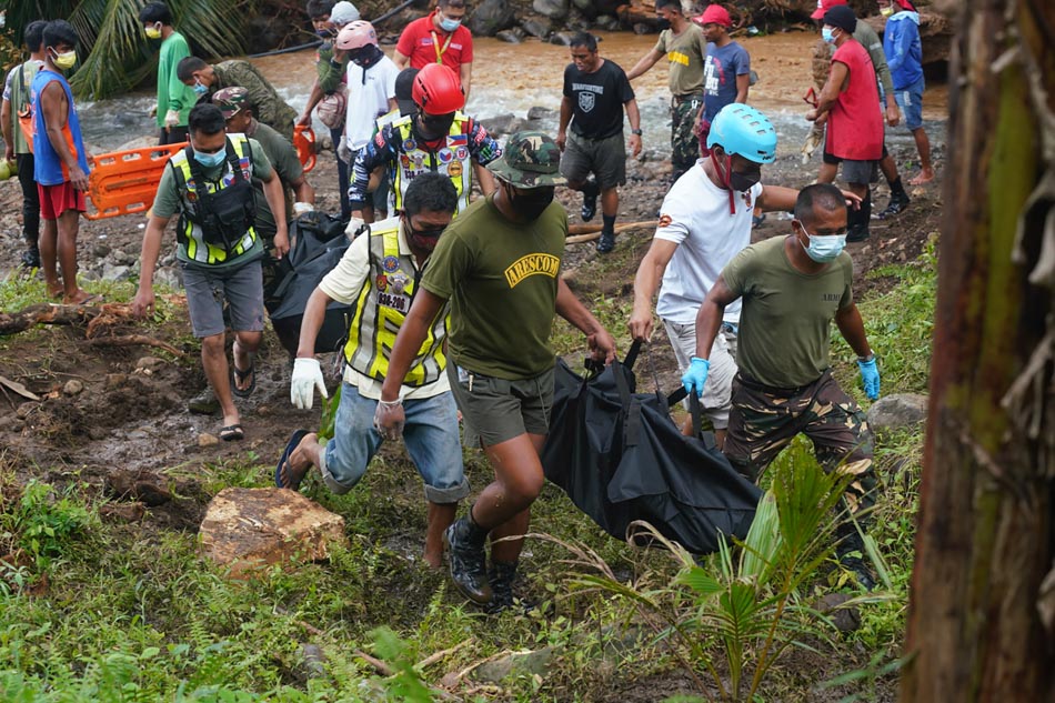 Rescue workers carry body bags containing the retrieved bodies of victims of a landslide that slammed the village of Bunga in Baybay town, Leyte province on April 13, 2022, days after heavy rains inundated the town brought about by Tropiical storm Megi. Bobbie Alota, AFP