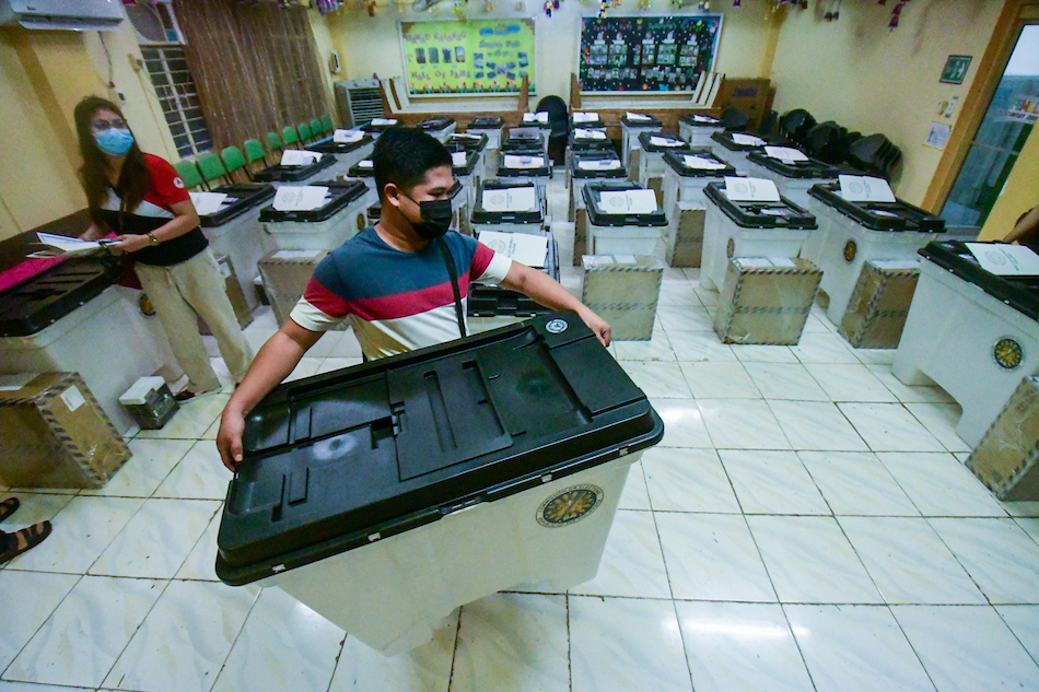 Members of the Electoral Board and poll watchers conduct their final testing and sealing of vote counting machines at Melencio M. Castelo Elementary School in Quezon City on Tuesday. Mark Demayo, ABS-CBN News/File