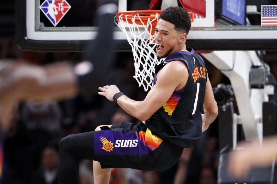 Devin Booker #1 of the Phoenix Suns reacts after dunking the ball during the first half against the Los Angeles Lakers at Footprint Center on March 13, 2022 in Phoenix, Arizona. File photo. Chris Coduto, Getty Images/AFP.