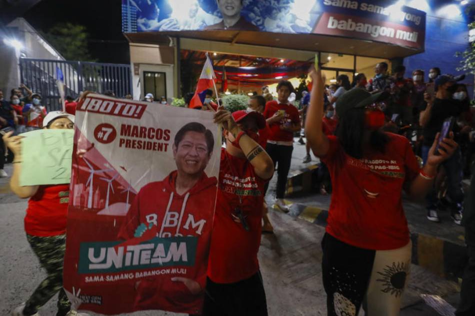 Supporters of presidential candidate Ferdinand 'Bongbong' Marcos Jr. cheer outside his campaign headquarters in Mandaluyong City, May 9, 2022. Rolex Dela Pena, EPA-EFE 