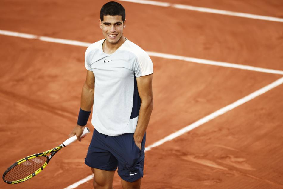 Carlos Alcaraz of Spain stands on court and smiles after winning the men's second round match against Albert Ramos-Vinolas of Spain during the French Open at Roland ​Garros in Paris, France, 25 May 2022. Yoan Valat, EPA-EFE