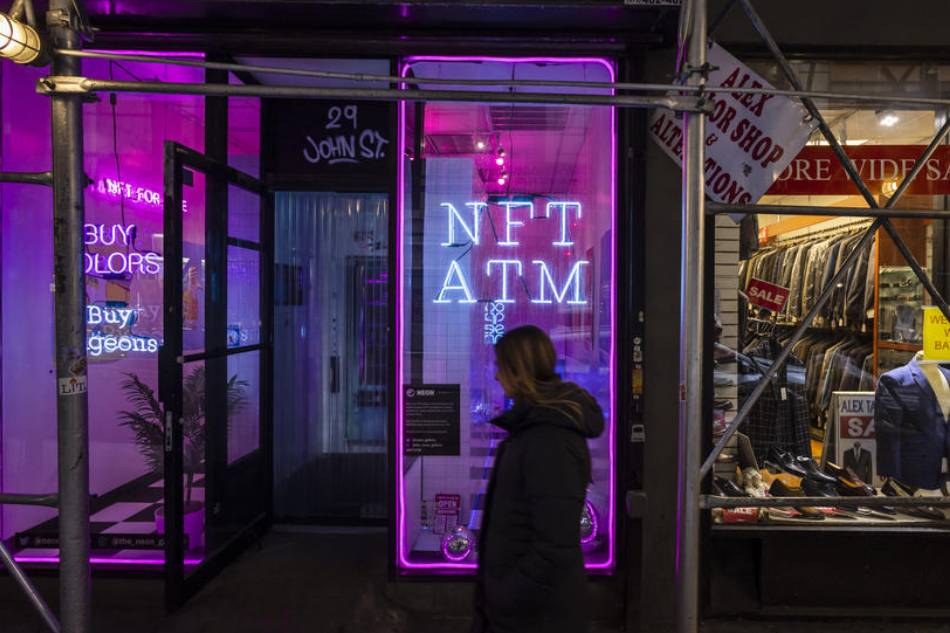 People walk past an NFT (non-fungible token) ATM in a small storefront in the Financial District of New York, New York, USA, 03 March 2022. Justine Lane, EPA - EFE