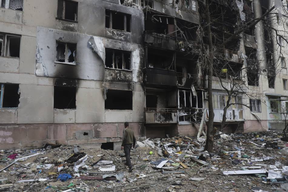 A man walks past a residential building damaged during a shelling in Severodonetsk, North-West of Luhansk, Ukraine, on April 16, 2022. EPA-EFE/file