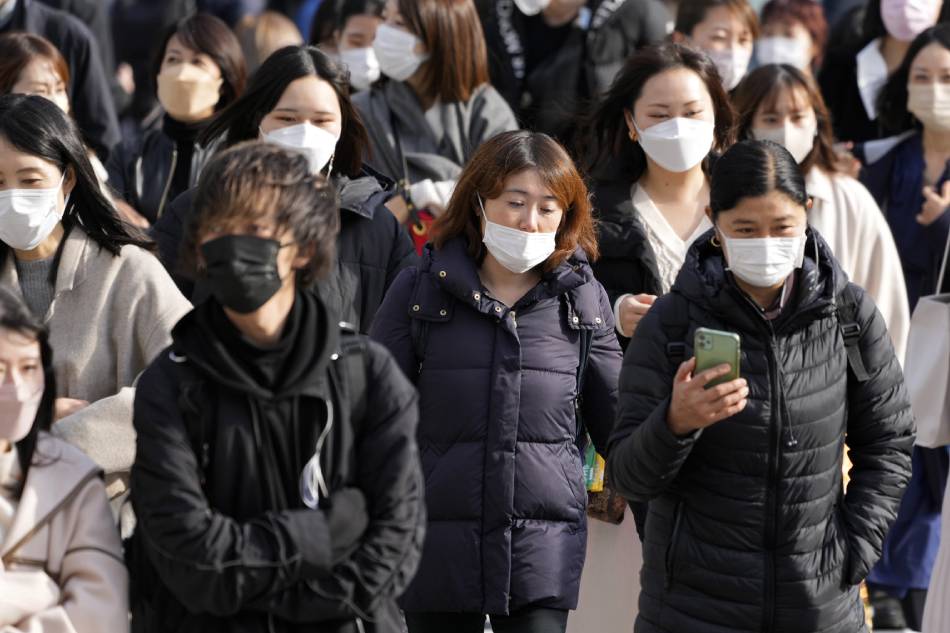 Pedestrians wearing protective face masks crowd a street at the Omotesando fashion district in Tokyo, Japan, Nov. 30, 2021. Franck Robichon, EPA-EFE/File