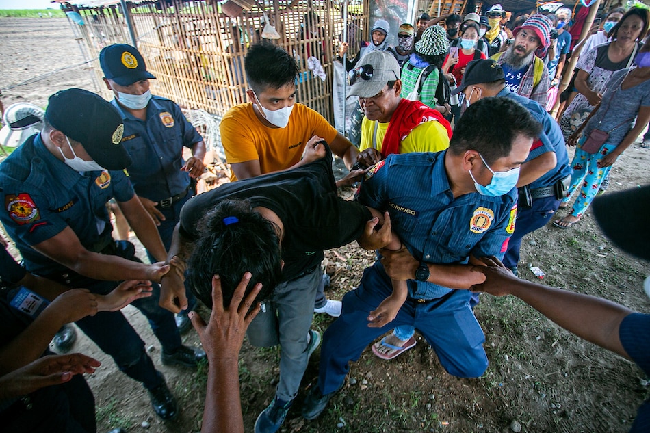  Police in Concepcion, Tarlac arrest people on June 9, 2022 after a group of activists, cultural workers, and local farmers cultivated a piece of disputed land in Tinang village. Mark Saludes, ABS-CBN News/file