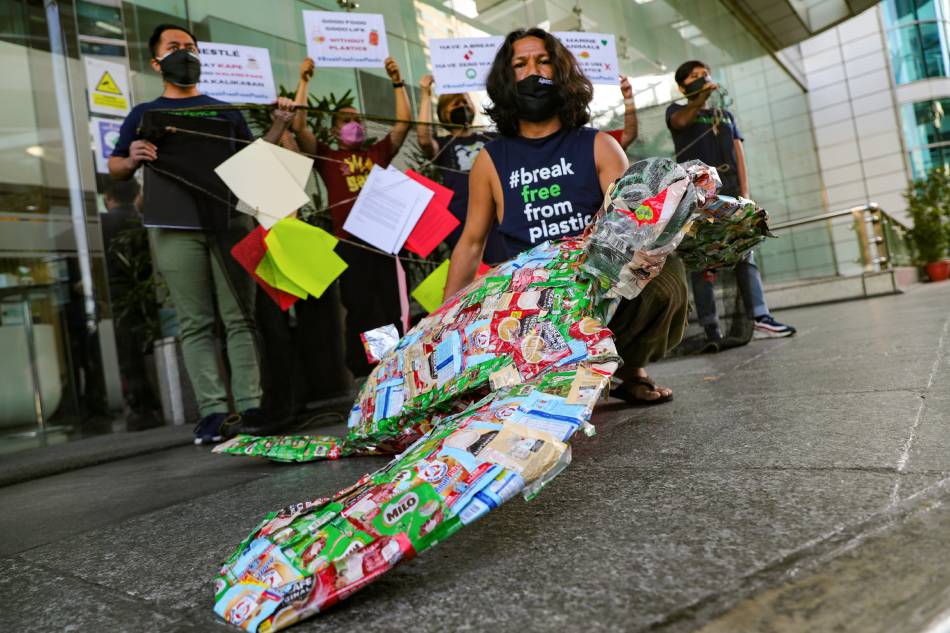 Environmental activists deliver a turtle sculpture made of single-use plastic sachets as they dramatize the impacts of plastic wastes on the marine environment, during a protest in Makati City on March 23, 2022. Jonathan Cellona, ABS-CBN News