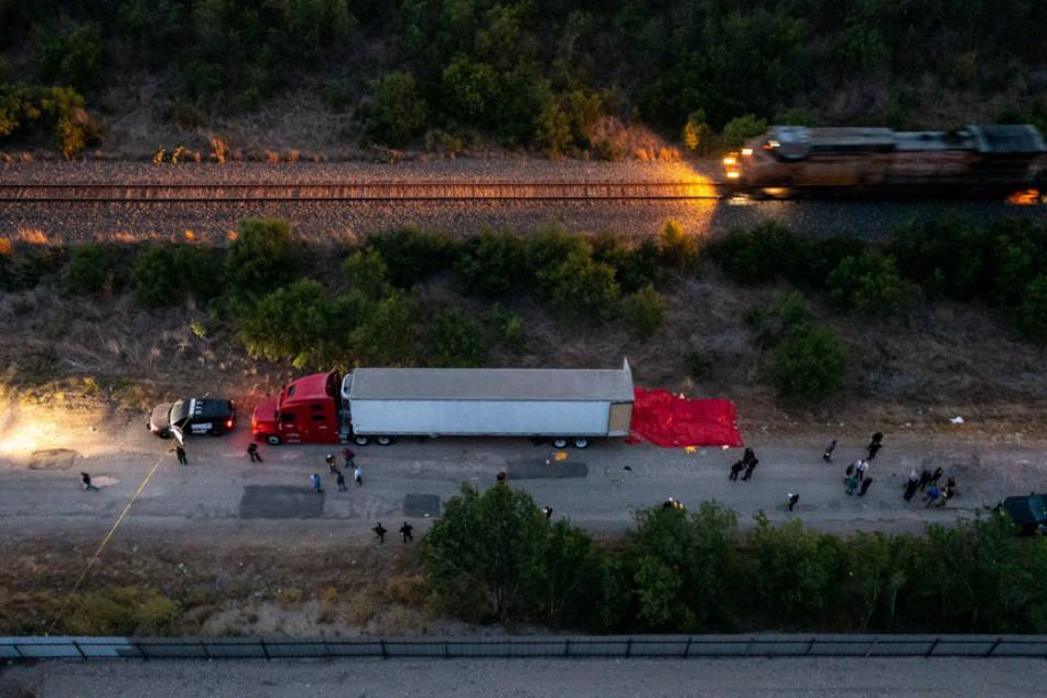 In this aerial view, members of law enforcement investigate a tractor trailer on June 27, 2022 in San Antonio, Texas. According to reports, at least 46 people, who are believed migrant workers from Mexico, were found dead in an abandoned tractor trailer. Over a dozen victims were found alive, suffering from heat stroke and taken to local hospitals. Jordan Vonderhaar/Getty Images/AFP 