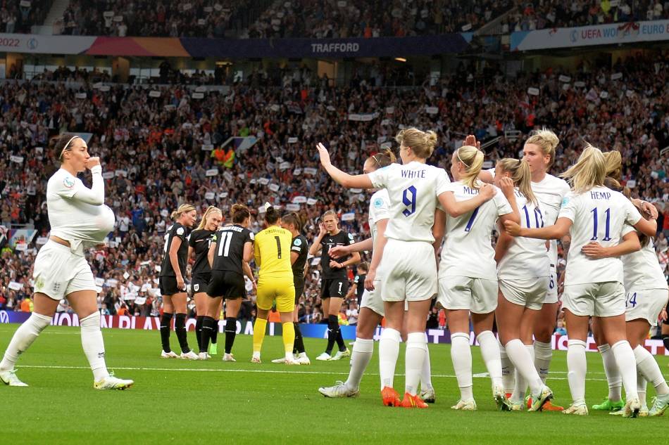 England's Beth Mead (5-th R, with back), together with her teammates, reacts after scoring the opening goal against Austria for the 1-0 lead during the opening match of the UEFA Women's EURO 2022 between England and Austria at the Old Trafford stadium in Manchester, Britain, 06 July 2022. Peter Powell, EPA-EFE.
