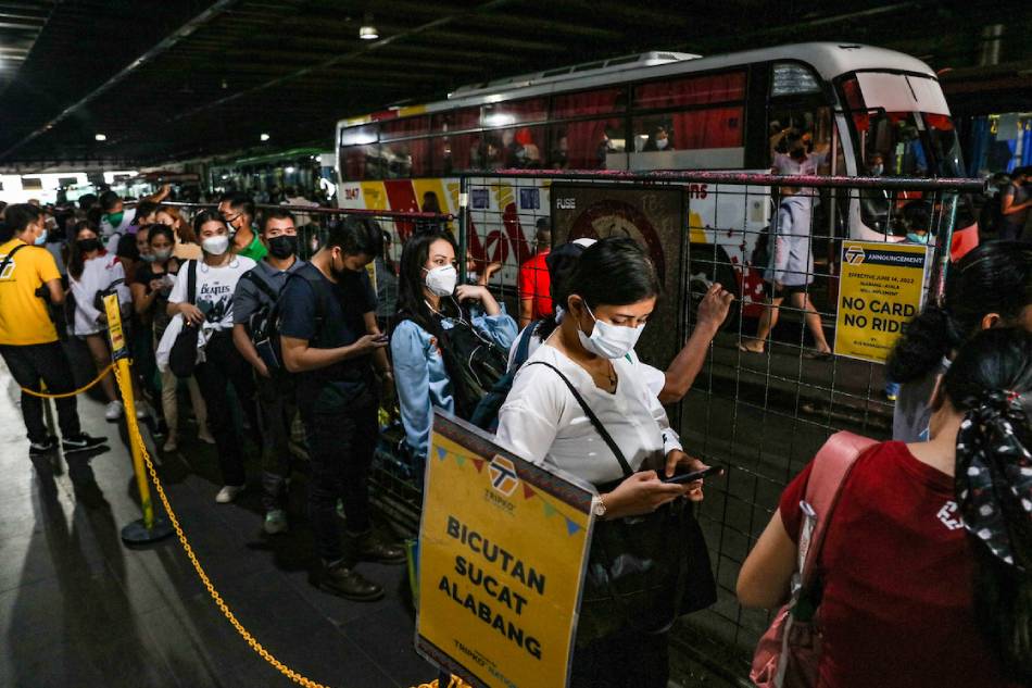 Commuters wait to board busses at the Ayala-EDSA bus stop in Makati City on June 15, 2022. Jonathan Cellona, ABS-CBN News