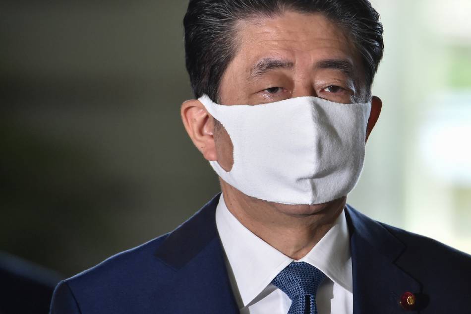 Japan's Prime Minister Shinzo Abe wearing a face mask arrives at the prime minister's office in Tokyo on Aug. 28, 2020. Kazuhiro Nogi, AFP/File