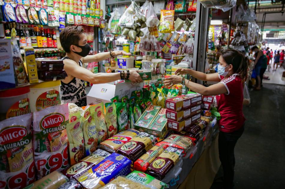 Market workers arrange their goods for sale inside the Suki Market in Quezon City on December 11, 2021. George Calvelo, ABS-CBN News/File