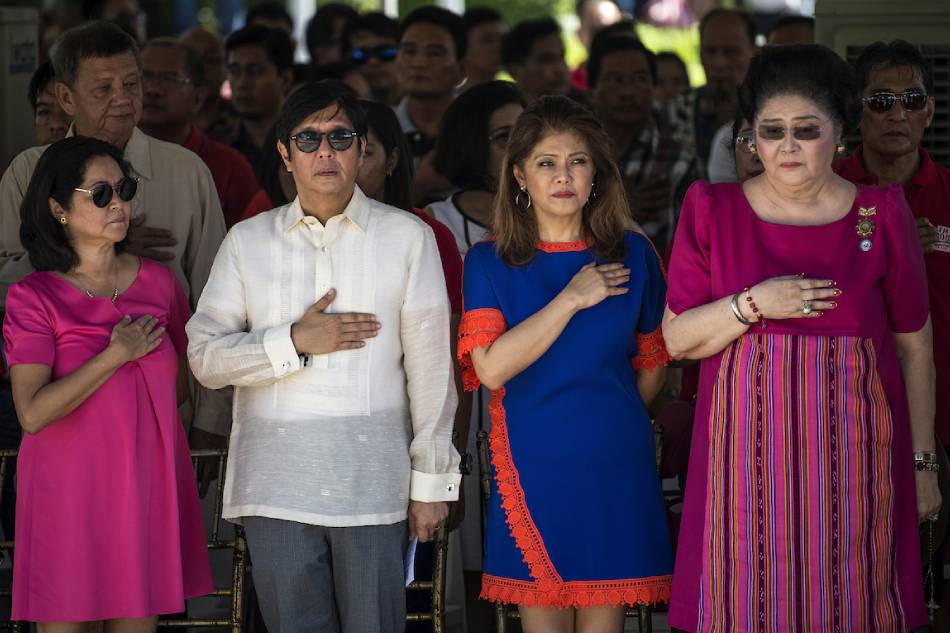 Ferdinand 'Bongbong' Marcos Jr. (2nd L), his sister Imee (2nd R) and their mother, former Philippine first lady Imelda Marcos(R), listen to the national anthem during a wreath-laying ceremony in Batac, Ilocos Norte province, north of Manila on Sept. 10, 2017. Noel Celis, AFP