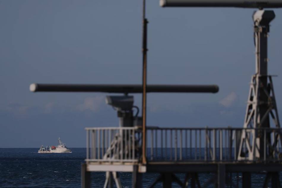A ship maneuvers past a radar tower as it sails away from the location where the Chinese military conducts a live fire drill, is seen from the coast of New Taipei city, Taiwan, on August 4, 2022. Ritchie B. Tongo, EPA-EFE