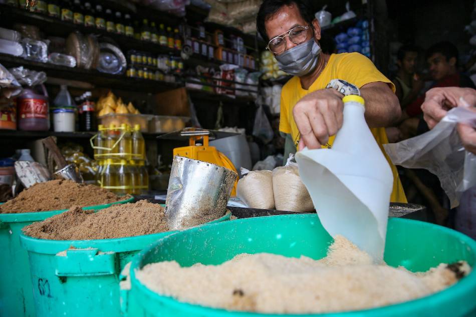 Vendors sell sugar by the kilo at the Bagong Silang public market in North Caloocan on Aug. 11, 2022. Jonathan Cellona, ABS-CBN News