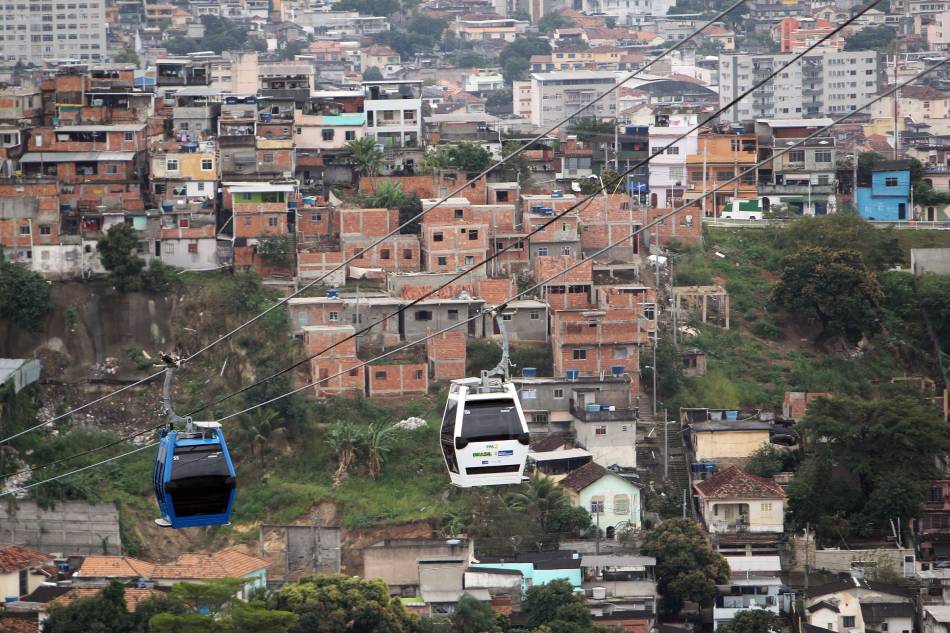Two cable cars are seen during the opening of a cable railway system at the Complexo do Alemão in Rio de Janeiro, Brazil, July 7, 2011. Complexo do Alemão is a group of favelas in the north of the city. Antonio Lacerda/EPA