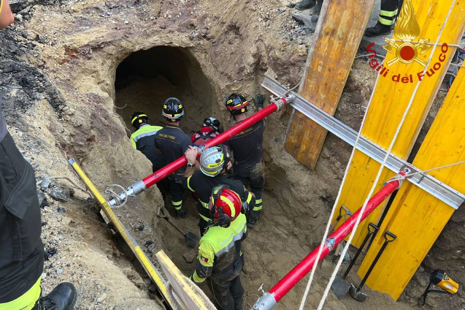 A Photo taken on August 11, 2022 in Rome and handout on August 12, 2022 by the Italian Firefighters Corps. (Vigili del Fuoco), shows first responders during a rescuing operation for a suspected thief who was buried under rubble for about eight hours, as he was allegedly digging a tunnel with his accomplices, presumably to rob a bank. According to media reports, the man and three accomplices, who were arrested near the empty shop under which the tunnel began, were probably targeting a nearby bank and were planning to enter the bank's vault at the end of the week, on the occasion of the 15th of August, the feast of the Assumption, when the whole of Italy stops. Handout / Vigili del Fuoco / AFP
