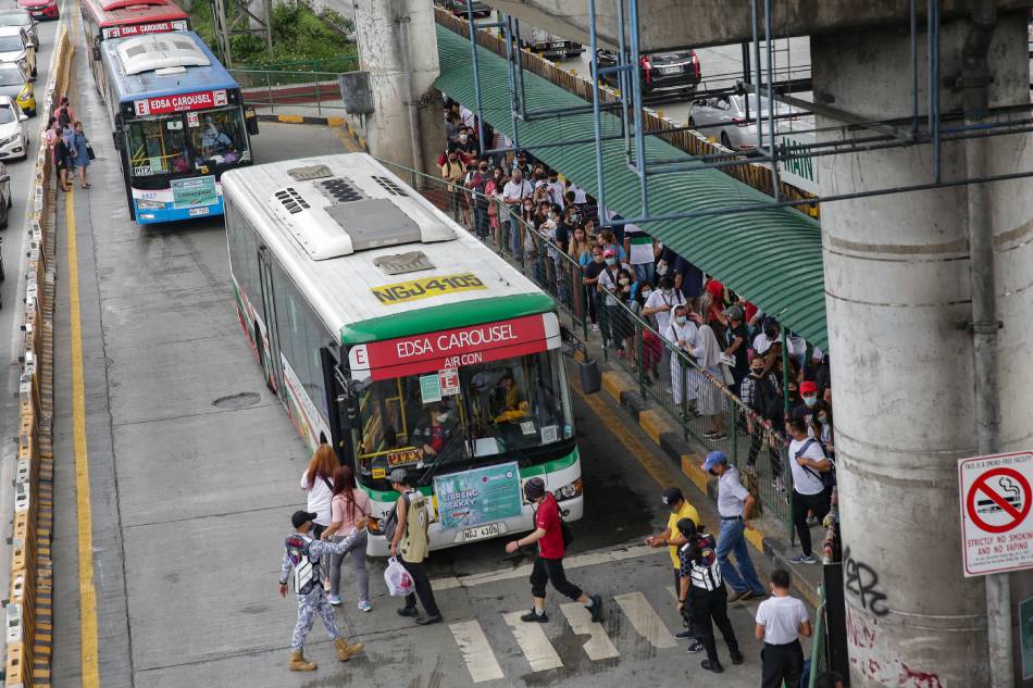 Commuters line up to take the EDSA Bus Carousel at the Main Avenue station Cubao, Quezon City on April 13, 2022.George Calvelo, ABS-CBN News